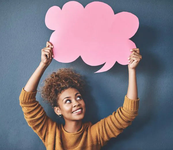 woman holding up a speech bubble